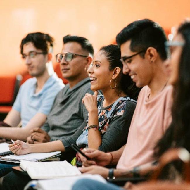 Students sitting in class smiling