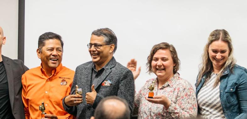 Faculty members being recognized at an awards ceremony