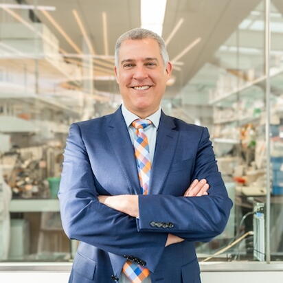 Dave Bearden smiles at camera in front of a laboratory window in the RLSB