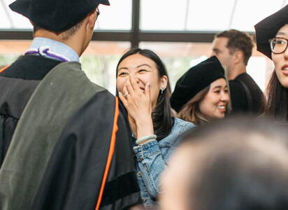 A family member smilies at a graduate