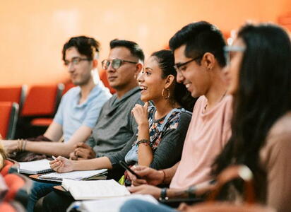 Students sitting in class smiling