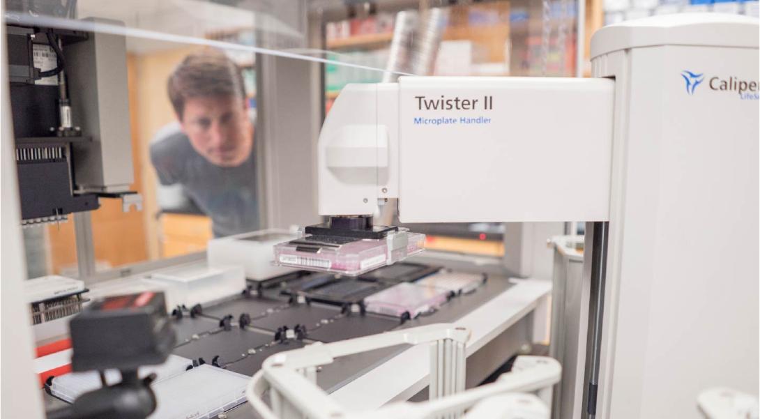 A man observes a machine at work